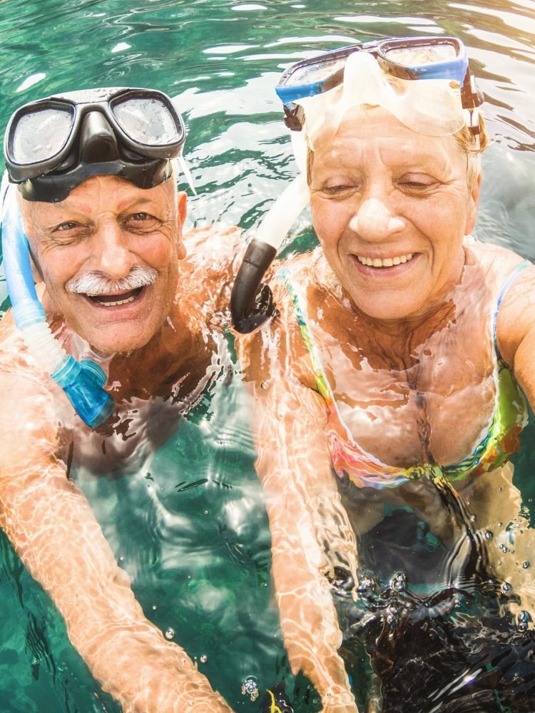 happy-retired-couple-taking-selfie-in-tropical-sea-2023-11-27-05-23-06-utc-min